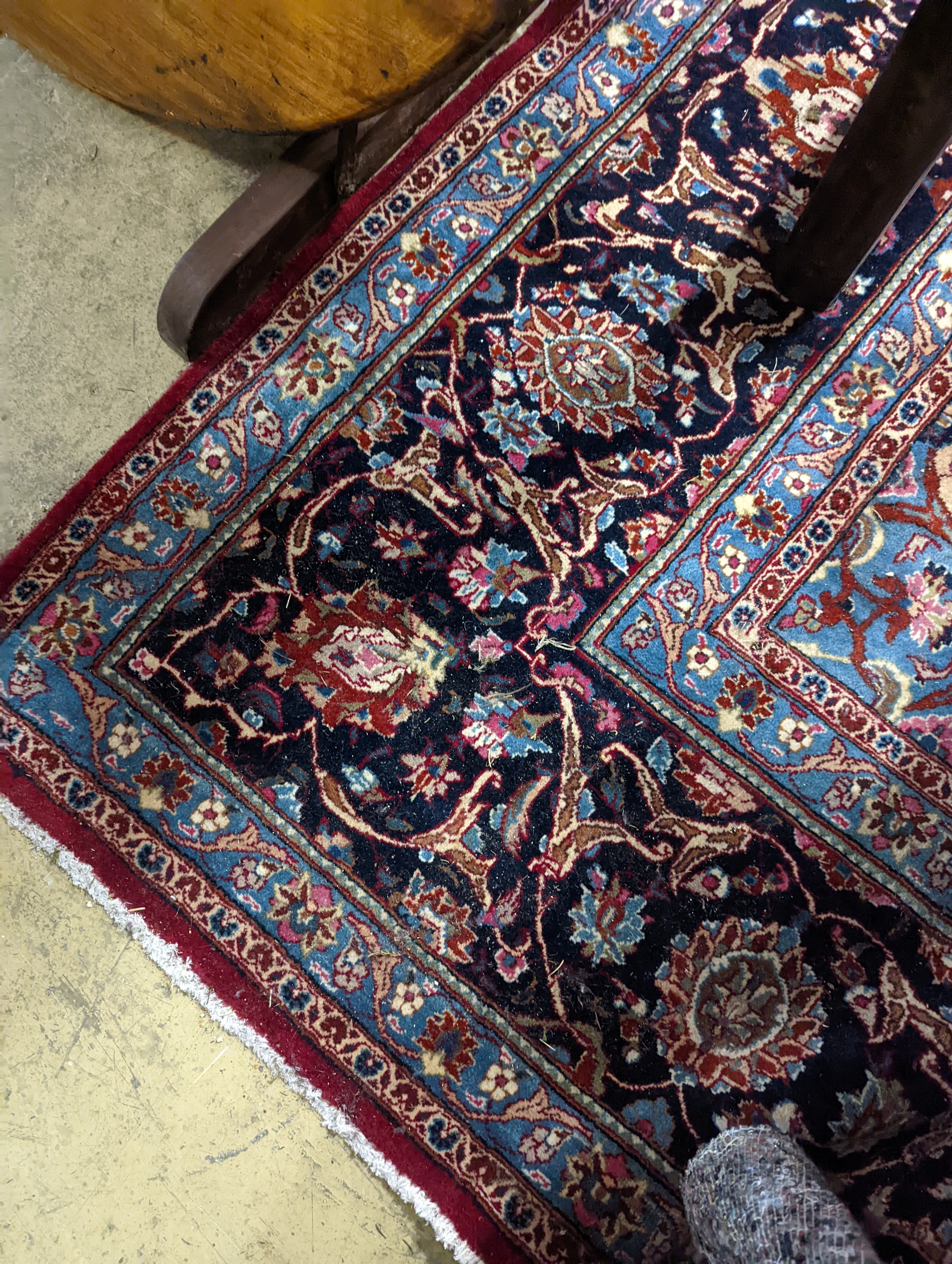 A Kashan burgundy ground carpet, 380 x 300cm